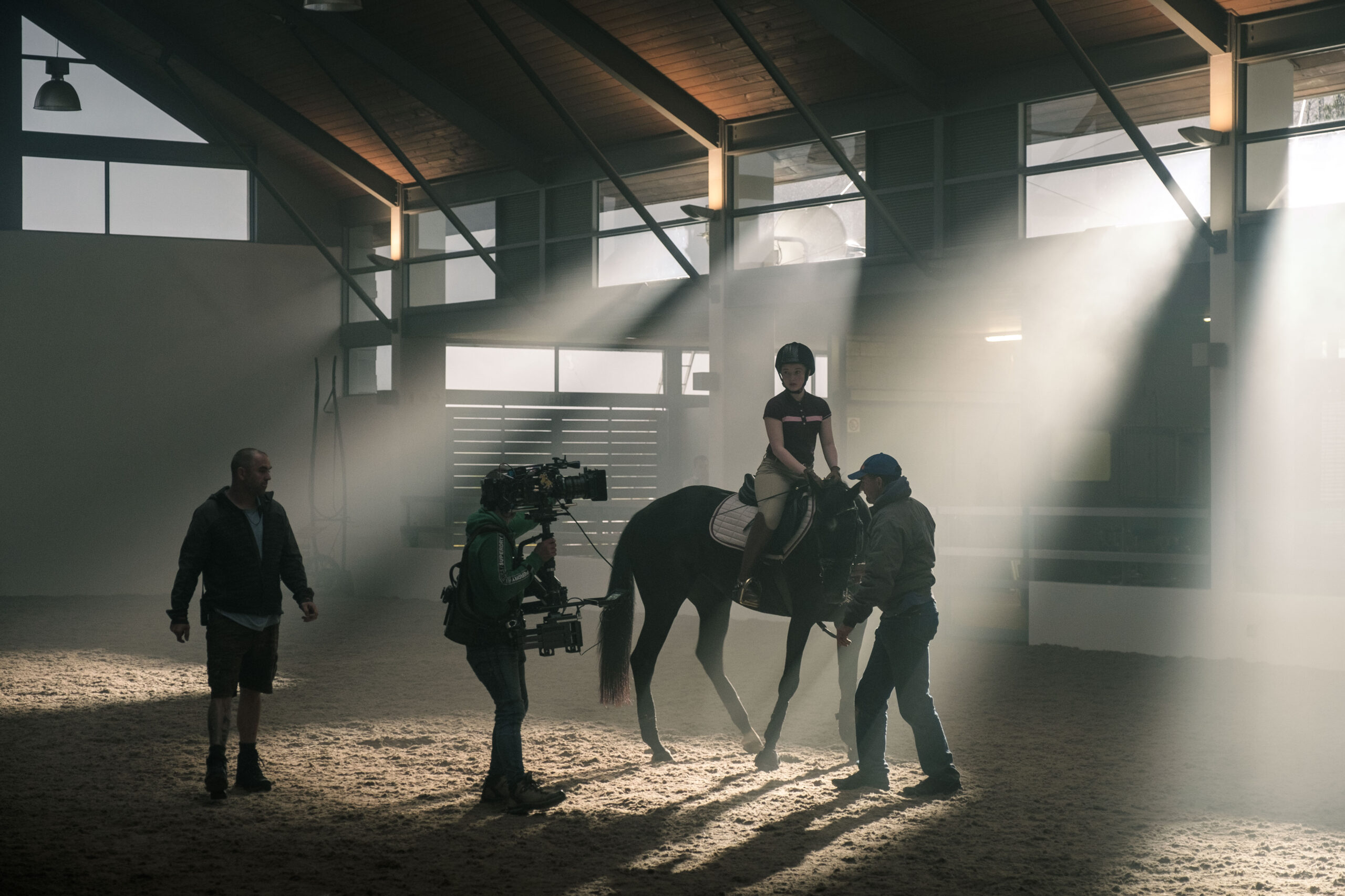 Behind the scenes girl on horse with camera rig on a movie set