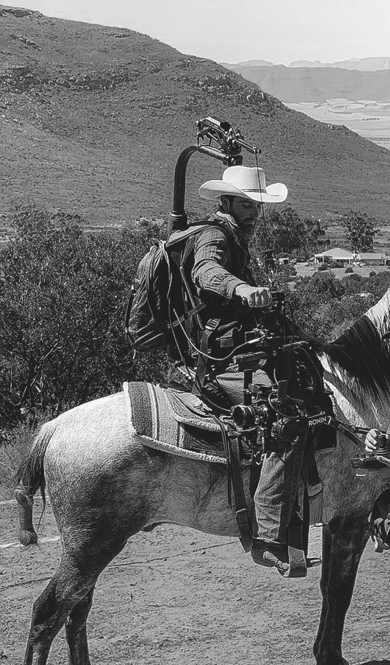 Film Equus stunt rider and liberty trainer, on a horse, with filming gear on a movie set