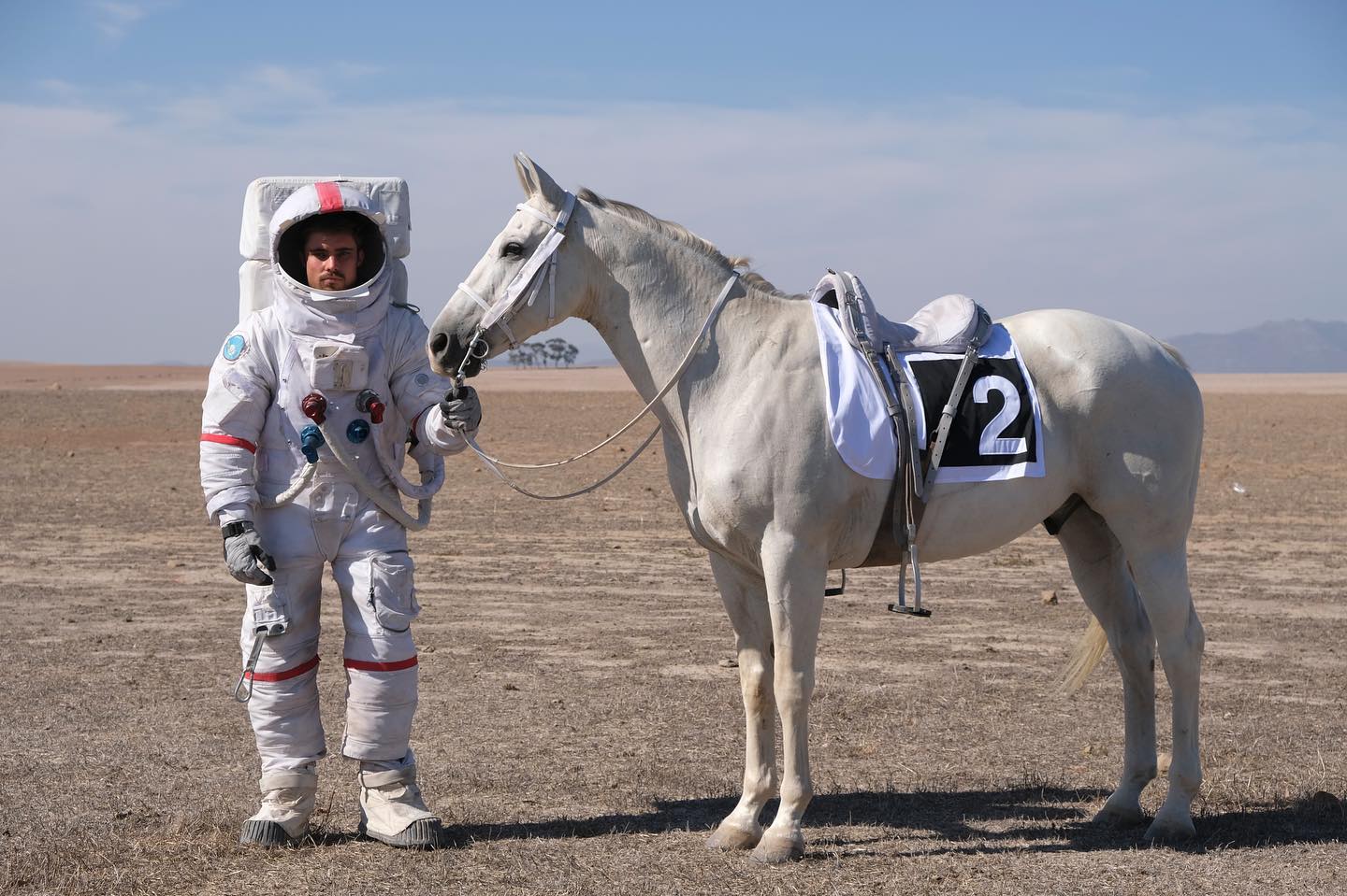 Stuntman dressed in a space suit with white horse for a PMU commercial in a space scene