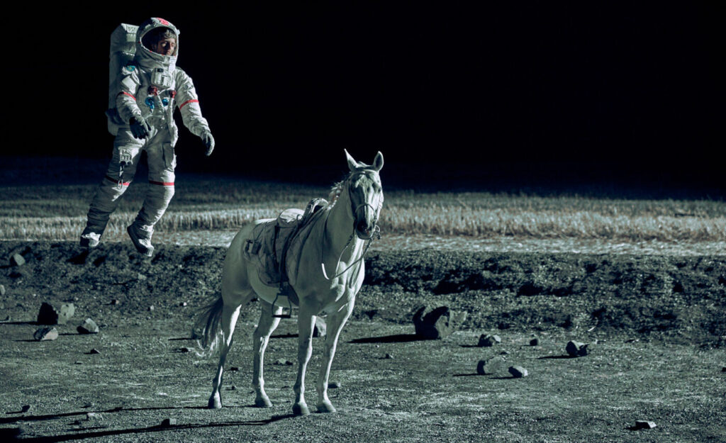 Stuntman dressed in a space suit with white horse for a PMU commercial in a space scene