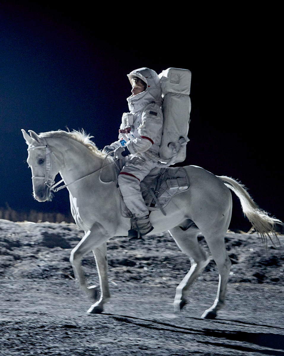 Stuntman dressed in a space suit on a white horse for a PMU commercial in a space scene