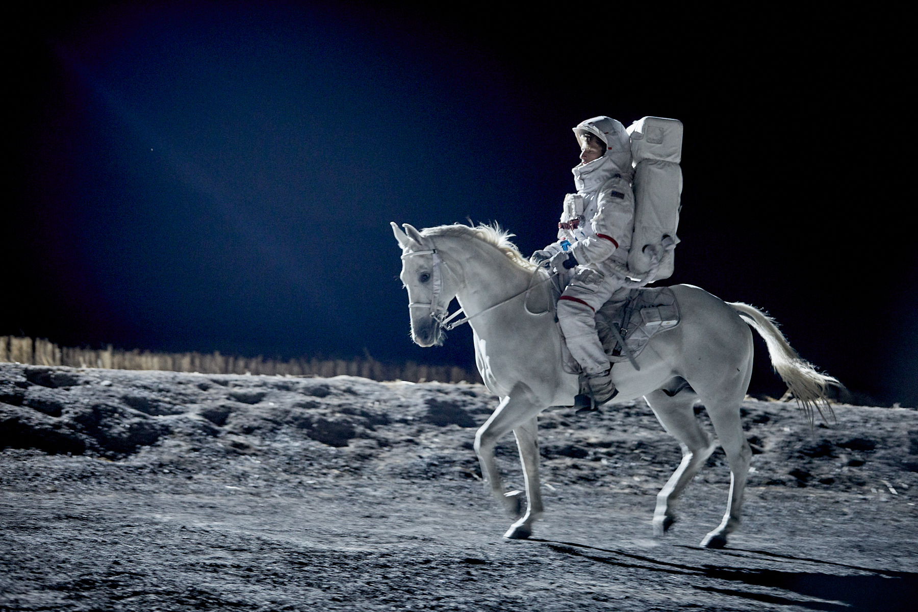 Stuntman dressed in a space suit on a white horse for a PMU commercial in a space scene