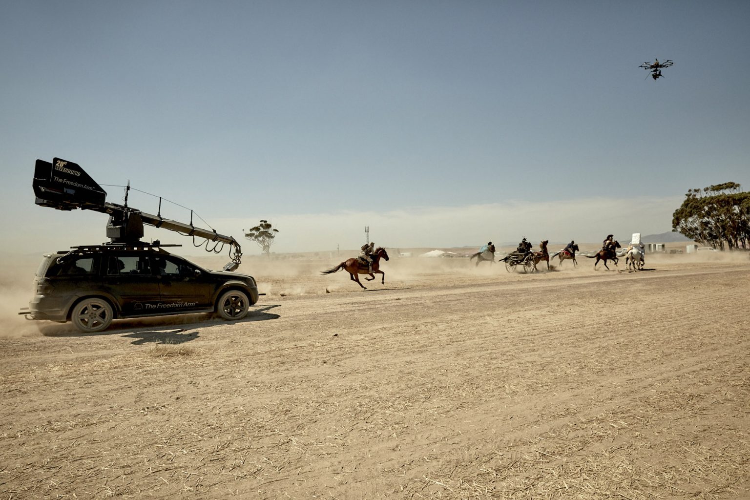 Behind the scenes on PMU commercial set in a desert setting with horses galloping